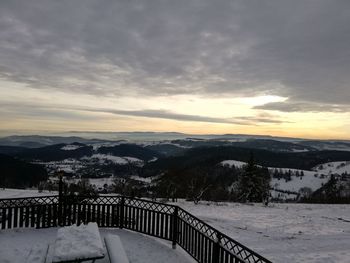 Scenic view of snow covered mountains against sky during sunset