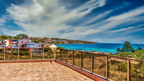 View of swimming pool by sea against sky