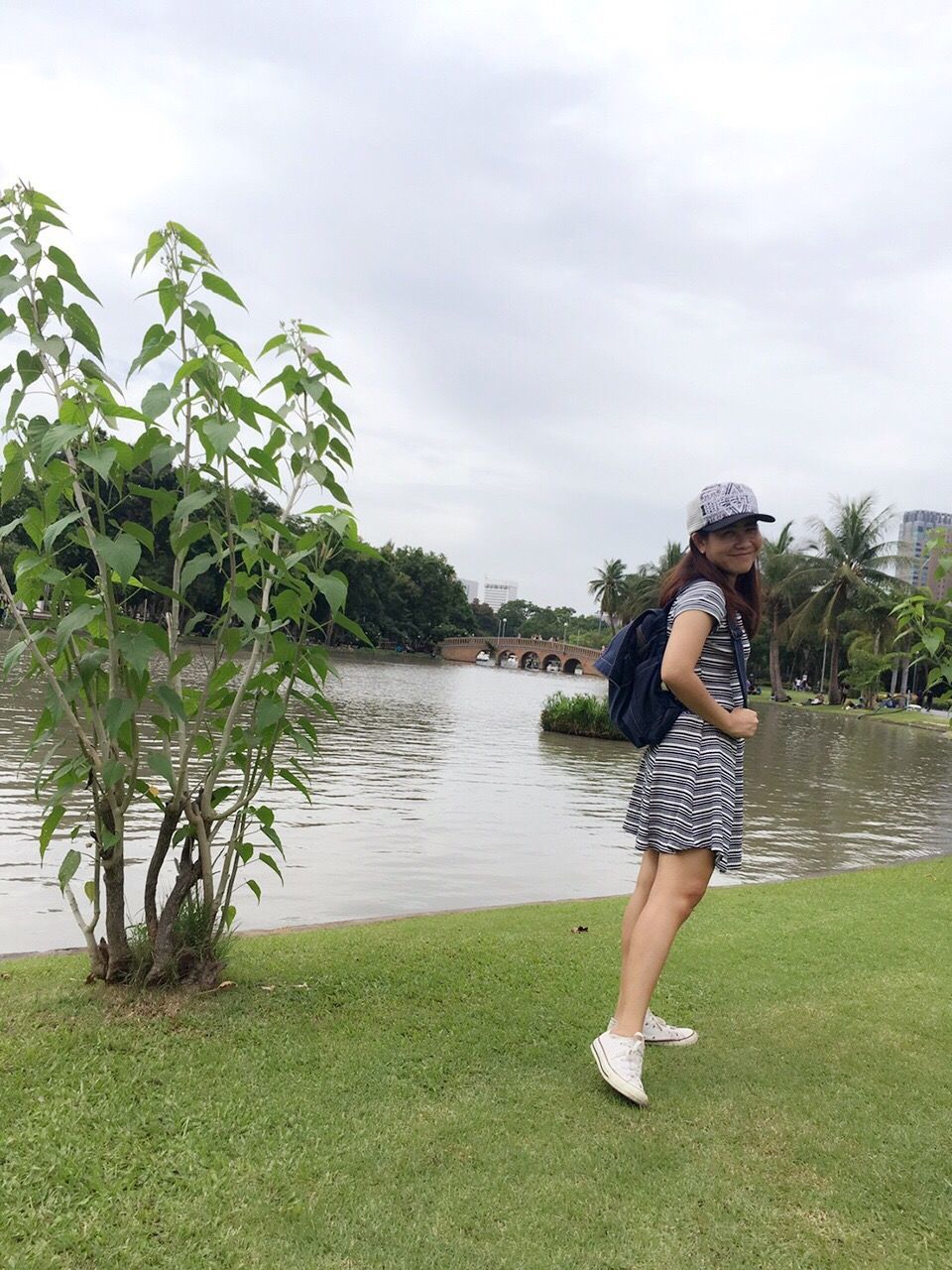 leisure activity, one person, standing, grass, tree, full length, sky, water, outdoors, casual clothing, real people, day, nature, lifestyles, young women, young adult, people