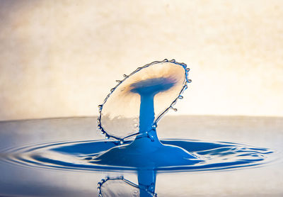 Close-up of eyeglasses on table against wall