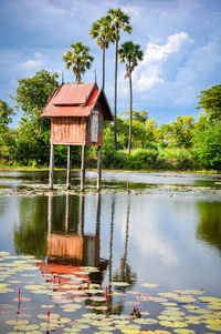 Gazebo by lake against sky