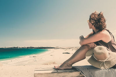 Young woman sitting on beach