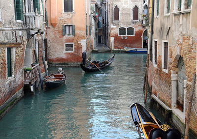 Boats in canal along buildings