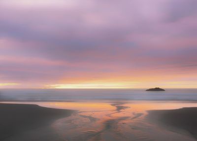 Scenic view of sea against sky at sunset