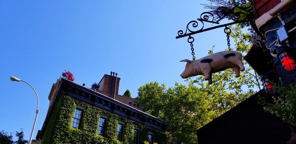 Low angle view of statue in city against clear sky