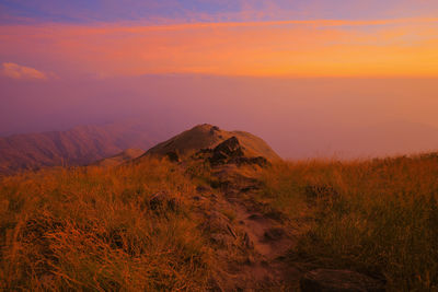 Scenic view of land against sky during sunset