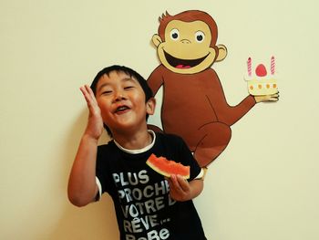 Portrait of smiling boy against wall