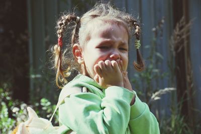 Close-up portrait of cute girl outdoors