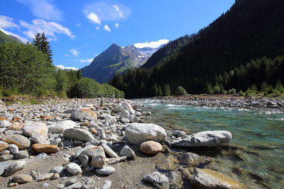 Scenic view of river with mountains in background