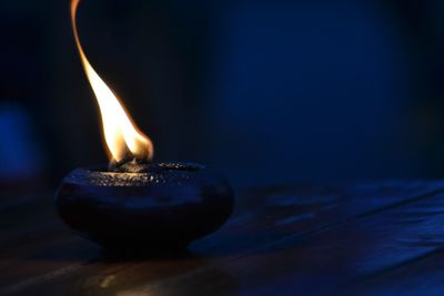 Close-up of lit candles on table