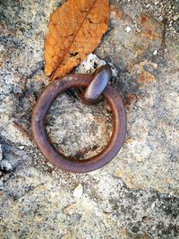 High angle view of rusty metal on rock