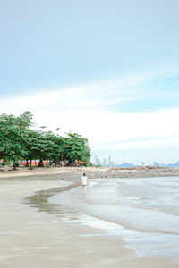 Man on beach against sky