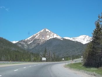 Road passing through snow covered mountains