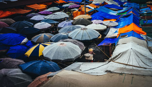 High angle view of colorful parasols at market during rainy season