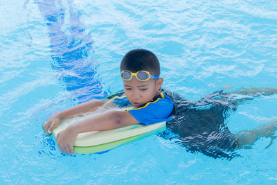 High angle view of boy swimming in pool