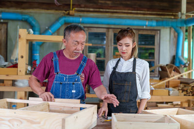 Portrait of young man standing in workshop