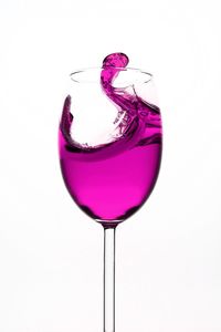 Close-up of wineglass over white background