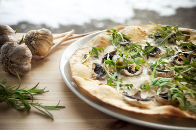 Close-up of truffle pizza served in plate on table