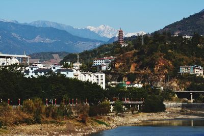 View of townscape by mountain against sky