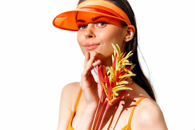 Portrait of young woman against white background