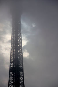 Low angle view of tower against cloudy sky