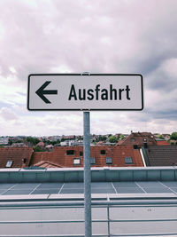 Information sign on roof against sky