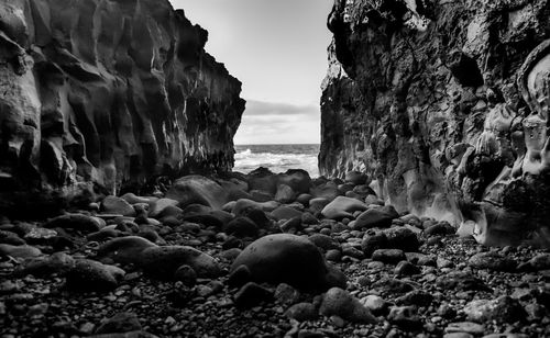 Rocks on beach against sky