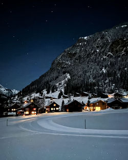 Scenic view of snowcapped mountains against sky at night