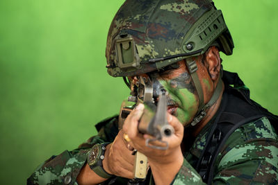 Portrait of mature man holding camera at home