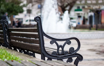 Close-up of empty bench in park