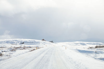 Tire tracks on snow covered landscape