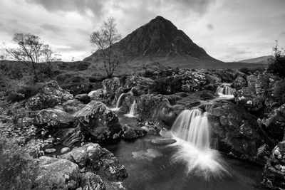 Scenic view of waterfall against sky