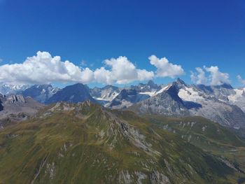 Scenic view of mountains against blue sky