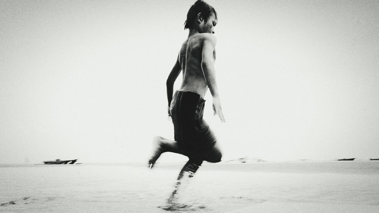 full length, one person, motion, beach, real people, leisure activity, sand, clear sky, lifestyles, young adult, outdoors, young women, day, people