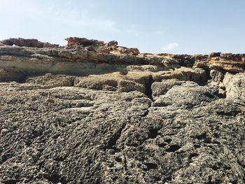 Rock formations on landscape against sky