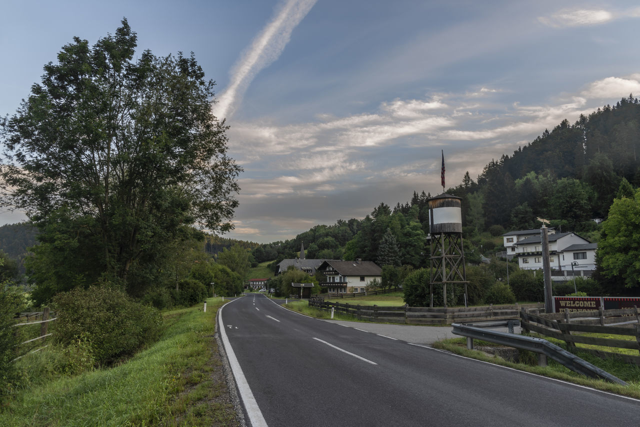 ROAD AMIDST TREES AGAINST SKY