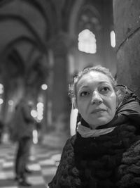 Woman looking away in corridor at night