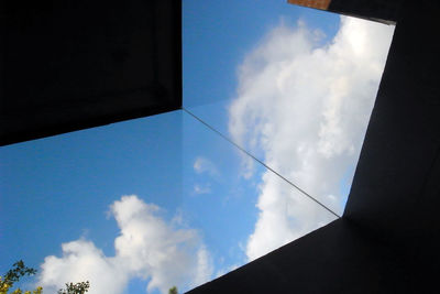 Low angle view of vapor trails against blue sky