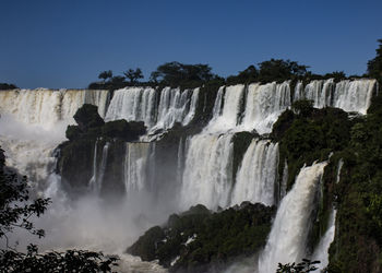 Scenic view of waterfall against sky