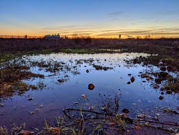 Scenic view of lake against sky during sunset