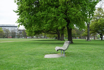 Wooden bench in the park view from side.