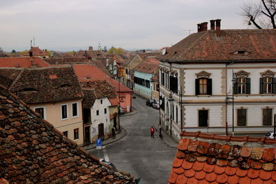 Houses in romanian town against cloudy sky