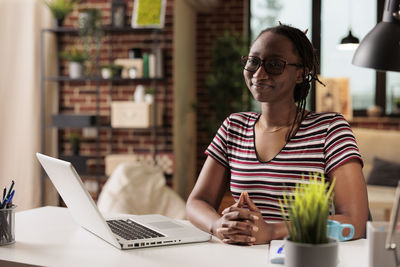 Young woman using laptop at office