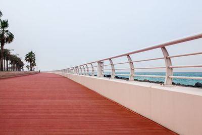 View of bridge over calm sea against clear sky