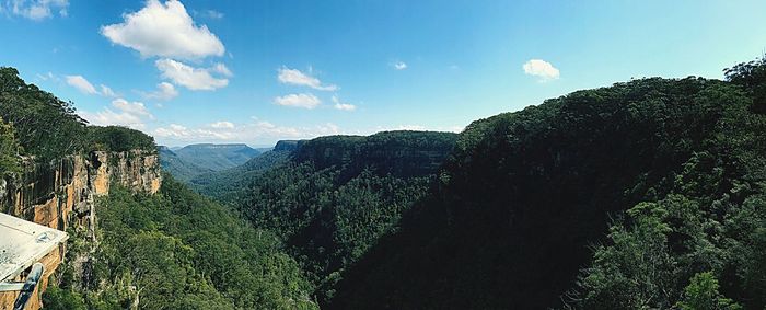 Panoramic view of trees and mountains against sky