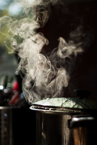 Close-up of steam emitting from cooking utensil