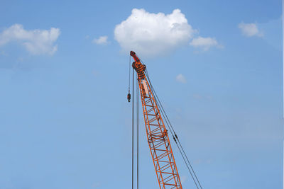 Low angle view of crane against sky