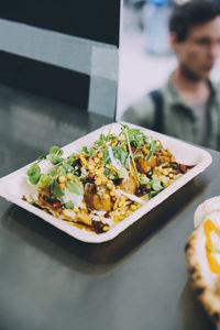 Close-up of indian food served in plate over commercial land vehicle