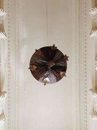 Low angle view of decoration hanging on ceiling against wall