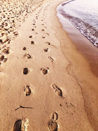 High angle view of footprints on beach